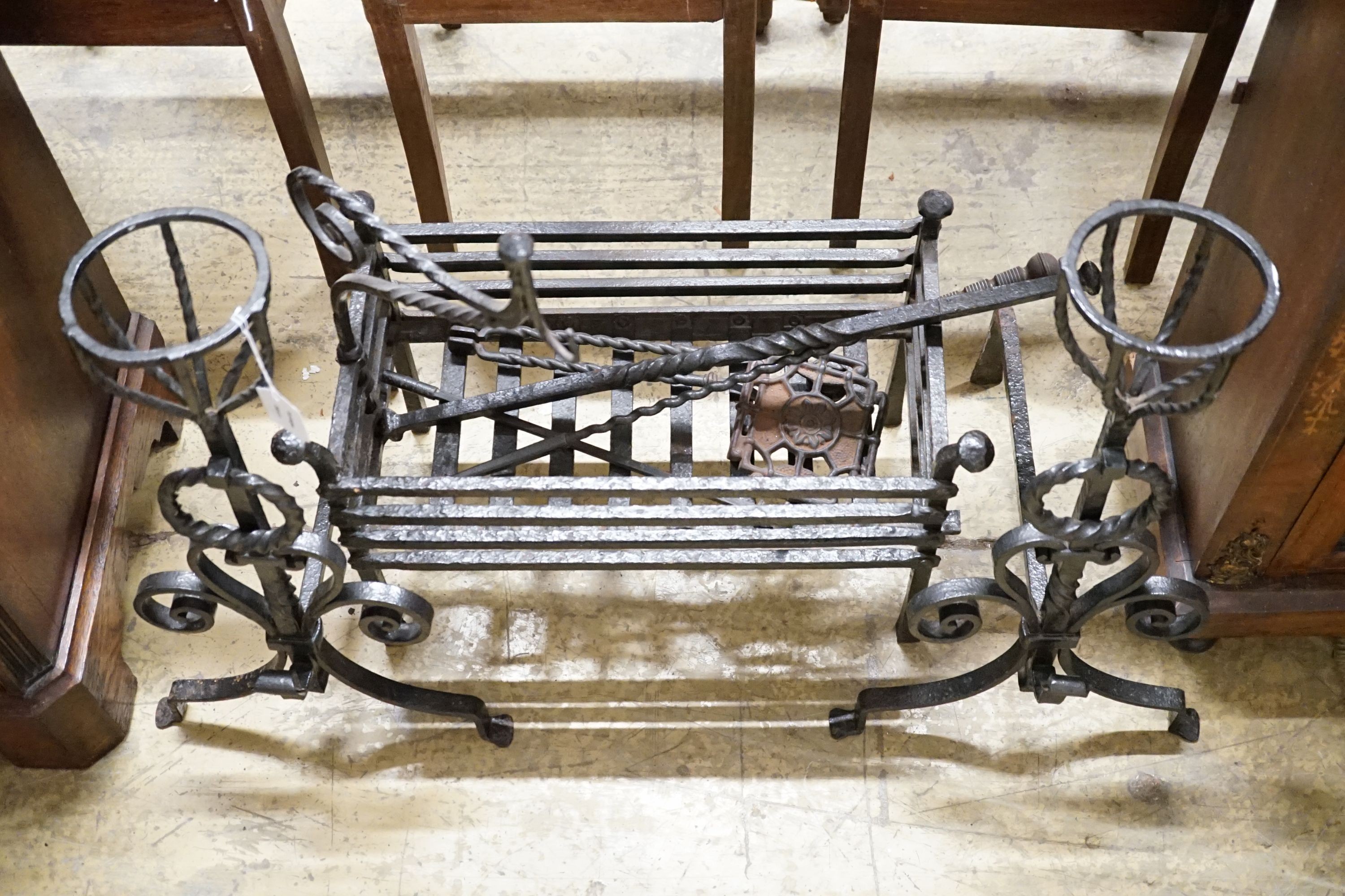 A group of wrought iron fireside effects including a pair of dogs, basket, 54 cm wide etc.